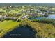 Aerial view of lakefront property with golf course and community at 8984 Houston Pl # 103, Orlando, FL 32819