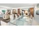 Open concept dining room with glass table and kitchen views at 8984 Houston Pl # 103, Orlando, FL 32819