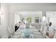 Open concept dining room with glass top table and water views at 8984 Houston Pl # 103, Orlando, FL 32819