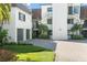 Exterior view of condo building with attached garage and paved driveway at 8984 Houston Pl # 103, Orlando, FL 32819