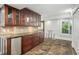 Kitchen with wood cabinets, granite countertops, and a breakfast bar at 8984 Houston Pl # 103, Orlando, FL 32819