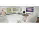 Living room with large TV, comfortable seating, and water views at 8984 Houston Pl # 103, Orlando, FL 32819