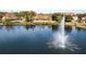 Community lake view with fountain and clubhouse in background at 8581 Bay Lilly Loop, Kissimmee, FL 34747