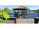 Wooden gazebo on a deck over a lake at 8581 Bay Lilly Loop, Kissimmee, FL 34747