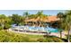 Inviting pool area with numerous lounge chairs and umbrellas at 8581 Bay Lilly Loop, Kissimmee, FL 34747