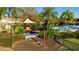 playground with swings and play equipment at 8581 Bay Lilly Loop, Kissimmee, FL 34747