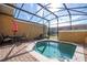 Relaxing screened pool and patio area with outdoor seating at 8581 Bay Lilly Loop, Kissimmee, FL 34747