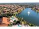 Aerial view of community with lake, homes, and clubhouse at 8581 Bay Lilly Loop, Kissimmee, FL 34747