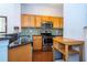 Kitchen features wood cabinets, granite countertops, and tile backsplash at 8581 Bay Lilly Loop, Kissimmee, FL 34747