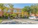 Townhome exterior; two-story, light yellow with lush landscaping at 8581 Bay Lilly Loop, Kissimmee, FL 34747