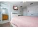 Main bedroom with a pink comforter and ensuite bathroom at 8581 Bay Lilly Loop, Kissimmee, FL 34747