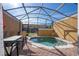 Screened pool area with patio furniture and lighting, perfect for relaxation at 8581 Bay Lilly Loop, Kissimmee, FL 34747