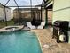 Private pool area with spa, grill, and lounge chairs at 2104 Fleming Mist Pl, Kissimmee, FL 34747