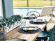 Outdoor patio table setting with blue and yellow plates and a centerpiece of greenery at 2104 Fleming Mist Pl, Kissimmee, FL 34747
