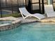 Relaxing poolside view with lounge chairs and spa at 2104 Fleming Mist Pl, Kissimmee, FL 34747