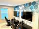 Game room with two gaming stations, large screens, and geometric wall art at 2104 Fleming Mist Pl, Kissimmee, FL 34747