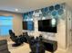 Game room with two gaming stations, large screens, and geometric wall art at 2104 Fleming Mist Pl, Kissimmee, FL 34747
