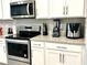 Modern kitchen with stainless steel appliances and white cabinets at 2104 Fleming Mist Pl, Kissimmee, FL 34747
