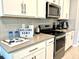 Modern kitchen with stainless steel appliances and white cabinets at 2104 Fleming Mist Pl, Kissimmee, FL 34747