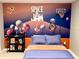 Bedroom with Space Jam mural, full-size bed, and floating shelves at 2104 Fleming Mist Pl, Kissimmee, FL 34747