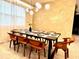 Modern dining room with a large table and stylish light fixture at 2104 Fleming Mist Pl, Kissimmee, FL 34747