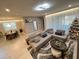 Spacious living area with sectional sofa, coffee table and a view into dining area at 2104 Fleming Mist Pl, Kissimmee, FL 34747