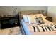 Bedroom with a bed, nightstand, and textured wall feature at 2104 Fleming Mist Pl, Kissimmee, FL 34747