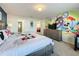 Mickey Mouse themed bedroom with large bed, dresser, and TV at 8931 Sydney Ave, Kissimmee, FL 34747