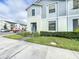 Two-story townhome with light blue siding and landscaped front yard at 8931 Sydney Ave, Kissimmee, FL 34747
