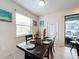 Dining room with a rustic wooden table and access to the backyard at 8931 Sydney Ave, Kissimmee, FL 34747