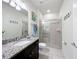 Bathroom with granite countertops, a single sink, and a shower/tub combo at 8931 Sydney Ave, Kissimmee, FL 34747