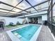Private screened pool area with lounge chairs and pergola at 8931 Sydney Ave, Kissimmee, FL 34747