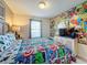 Bedroom with superhero bedding and large mural at 8931 Sydney Ave, Kissimmee, FL 34747