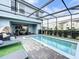 Relaxing pool area with covered patio and lounge chairs at 8931 Sydney Ave, Kissimmee, FL 34747