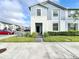 Two story light blue townhome with walkway at 8931 Sydney Ave, Kissimmee, FL 34747