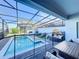 Screened-in pool and patio with outdoor furniture at 8931 Sydney Ave, Kissimmee, FL 34747