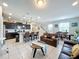Open living room and kitchen with dark brown leather couches and a dining area at 8931 Sydney Ave, Kissimmee, FL 34747