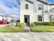 Two-story townhome with gray siding, a brick walkway, and landscaping at 8931 Sydney Ave, Kissimmee, FL 34747