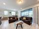 Living room with dark brown leather couches and access to a patio at 8931 Sydney Ave, Kissimmee, FL 34747