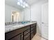 Bathroom with granite countertops and dark brown vanity at 8931 Sydney Ave, Kissimmee, FL 34747