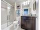 Bathroom with granite countertop, shower, and toilet at 8931 Sydney Ave, Kissimmee, FL 34747