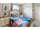 Bedroom with tropical bedding and a double dresser at 8931 Sydney Ave, Kissimmee, FL 34747