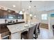 Spacious kitchen with granite countertops, dark wood cabinets, and stainless steel appliances at 8931 Sydney Ave, Kissimmee, FL 34747