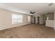 Large bonus room with plush brown carpet and ceiling fan at 1344 Holly Glen Run, Apopka, FL 32703