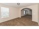 Bright and airy living room with carpeted floor and arched doorway at 1344 Holly Glen Run, Apopka, FL 32703
