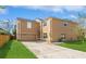 Tan two-story house with a two-car garage and landscaped lawn at 1344 Holly Glen Run, Apopka, FL 32703
