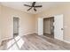 Bright bedroom with wood-look flooring and double doors to another room at 1344 Holly Glen Run, Apopka, FL 32703