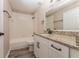 Bathroom with white vanity, granite countertop and tile shower/tub at 1344 Holly Glen Run, Apopka, FL 32703