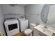 Laundry area with washer, dryer, and white vanity with a mirror at 4410 Shadow Crest # 2, Orlando, FL 32811