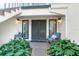 Condo entryway with a sitting area and lush plants at 8984 Houston Pl # 103, Orlando, FL 32819